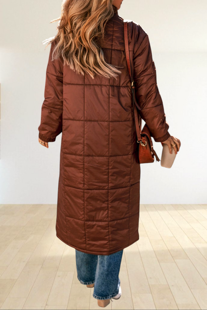 Baya Wear coffee brown mid-length quilted puffer jacket with stand neck, worn by a woman walking outdoors in autumn.