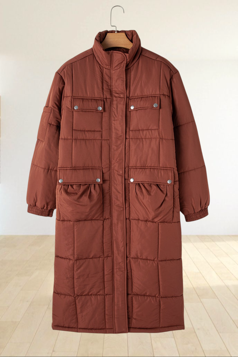 Baya Wear coffee brown mid-length quilted puffer jacket with a stand neck, zip closure, and utility flap pockets.