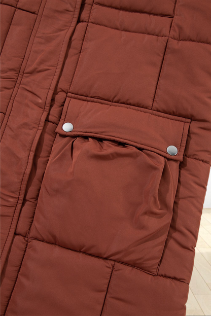 Close-up of a Baya Wear coffee brown quilted puffer jacket featuring a functional flap pocket with silver snap buttons.