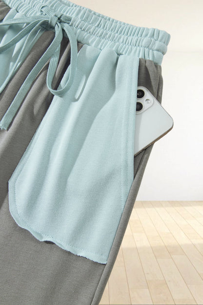 Baya Wear color block wide-leg lounge pants in light blue and grey with raw-edge pocket detail and drawstring waist