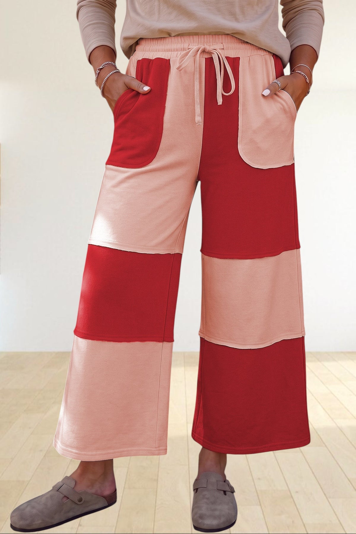 Baya Wear color block wide-leg lounge pants in red and peach with raw-edge seams, drawstring waist, and pockets.