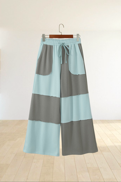 Baya Wear color block wide-leg lounge pants in light blue and grey with raw-edge seams and an adjustable drawstring.