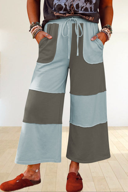 Baya Wear color block wide-leg lounge pants with raw-edge patchwork seams, drawstring waist, and side pockets.