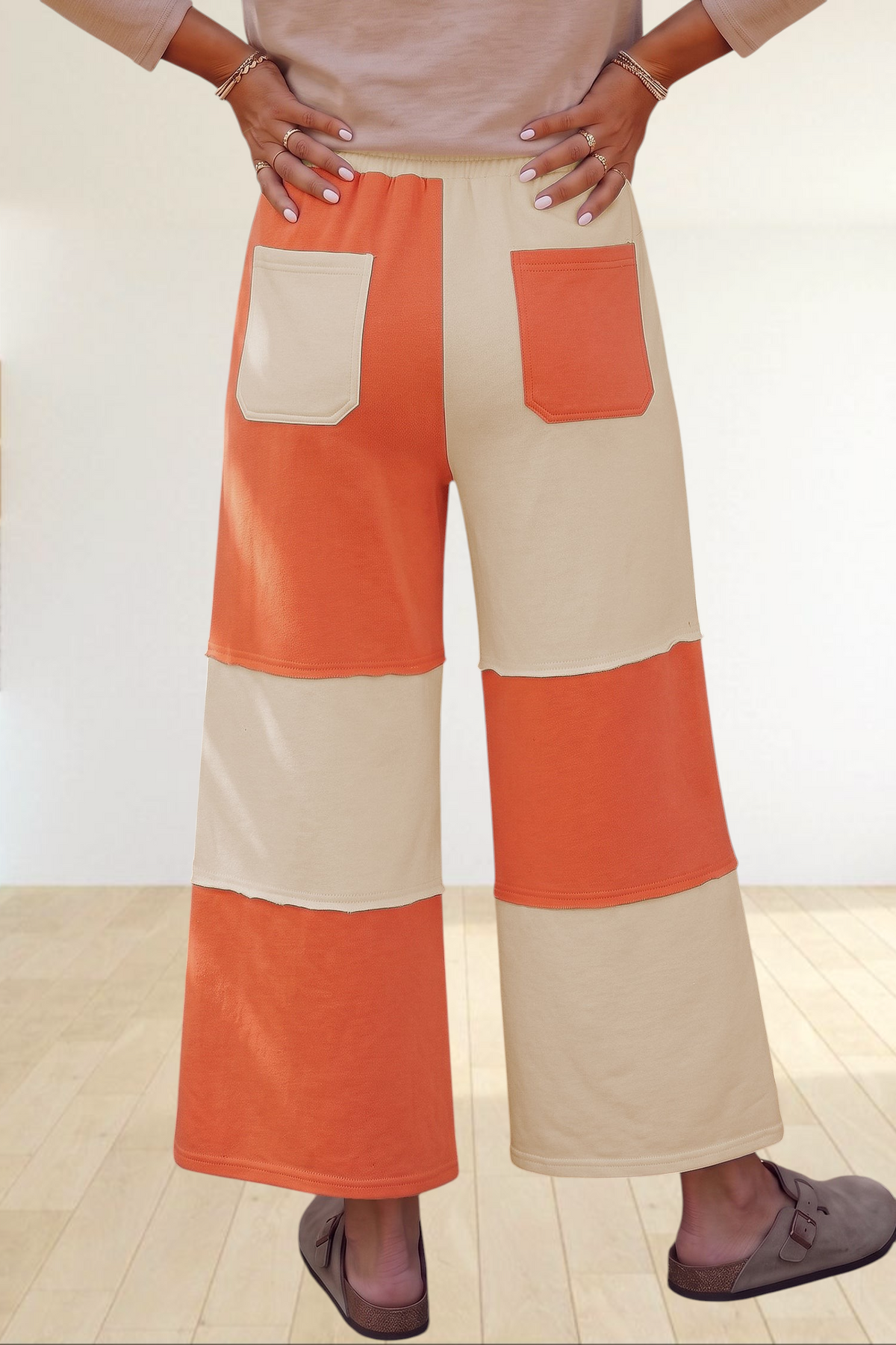 Baya Wear color block wide-leg lounge pants in orange and cream with raw-edge seams and back patch pockets