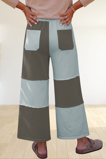 Baya Wear color block wide-leg lounge pants with raw-edge seams, back patch pockets, and an elastic drawstring waist.