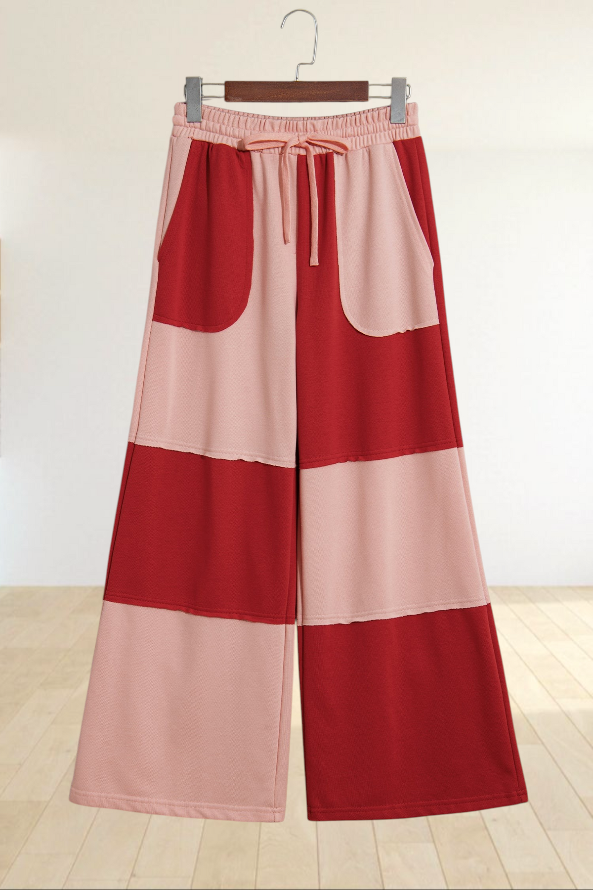 Baya Wear color block wide-leg lounge pants in red and pink with raw-edge seams, drawstring waist, and pockets.