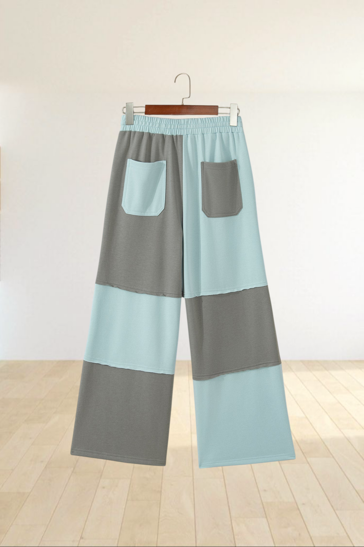 Baya Wear color block wide-leg lounge pants in blue and grey with raw-edge seams and back patch pockets.