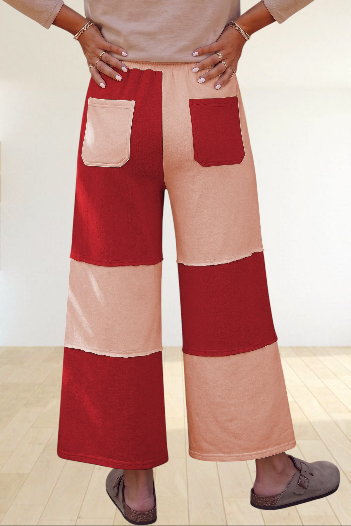 Baya Wear wide-leg lounge pants featuring a red and beige colorblock patchwork design with raw-edge seams and pockets.
