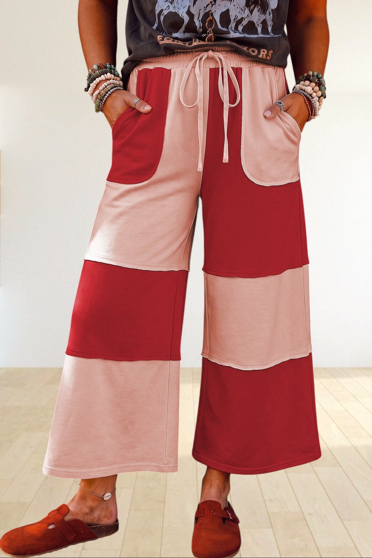 Baya Wear color block wide-leg lounge pants in red and beige with raw-edge seams, drawstring waist, and pockets.