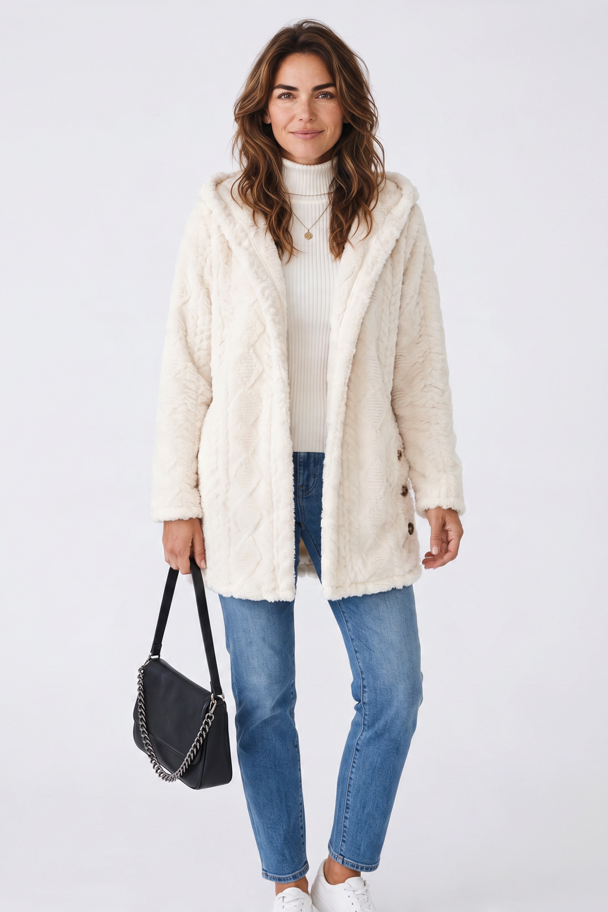 Model wearing a Baya Wear cream hooded fleece cardigan with cable texture, button front, and side button details.