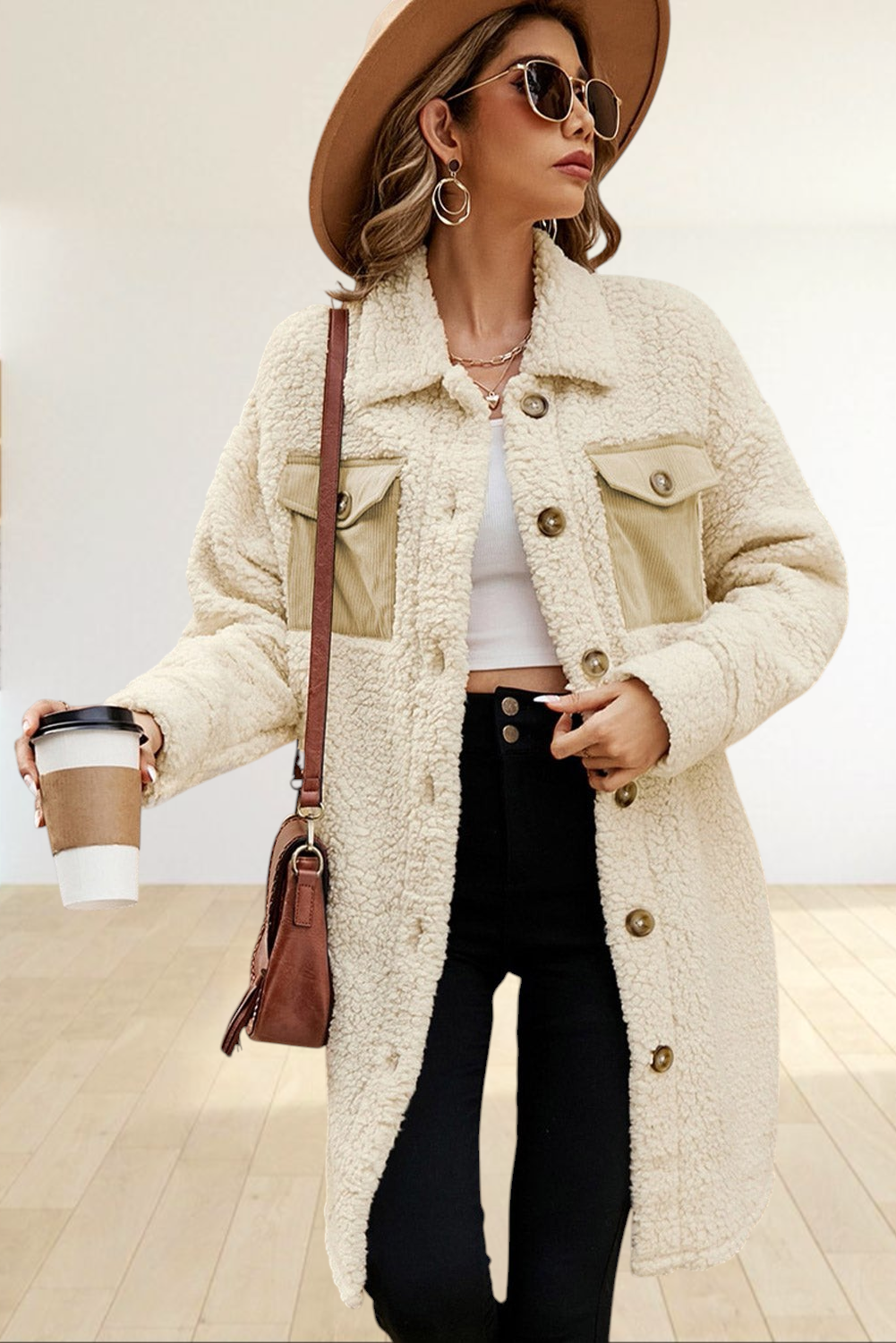 Baya Wear longline cream teddy fleece shacket with contrast corduroy chest pockets worn by a woman with a hat
