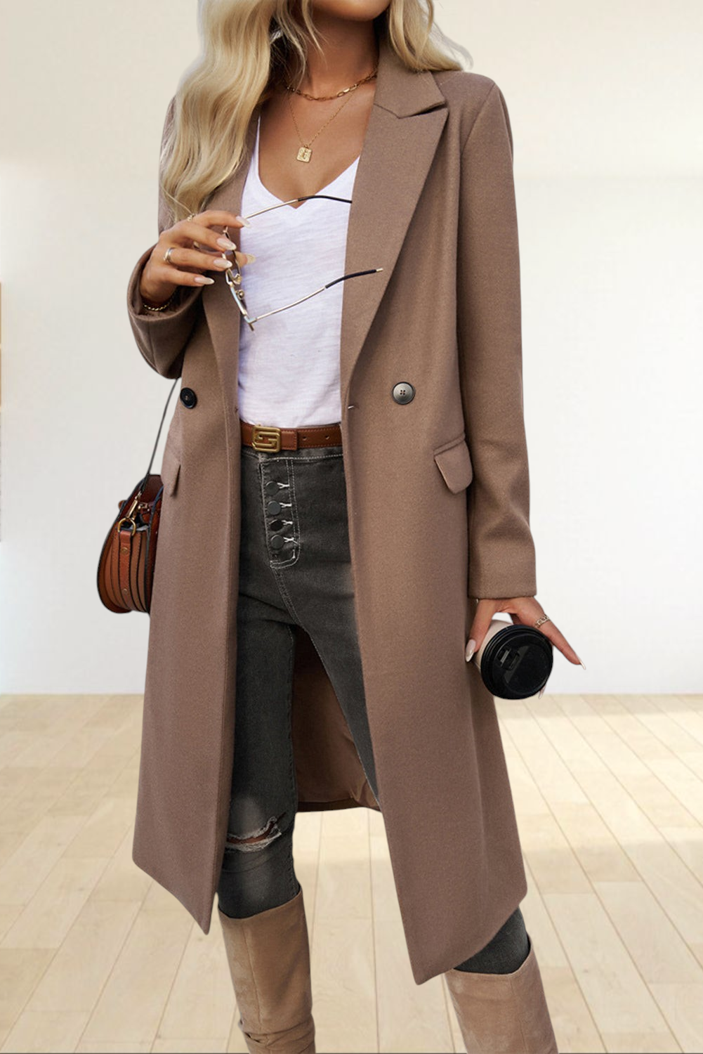 Baya Wear dark khaki longline single-breasted overcoat with lapel collar and flap pockets worn over jeans and boots