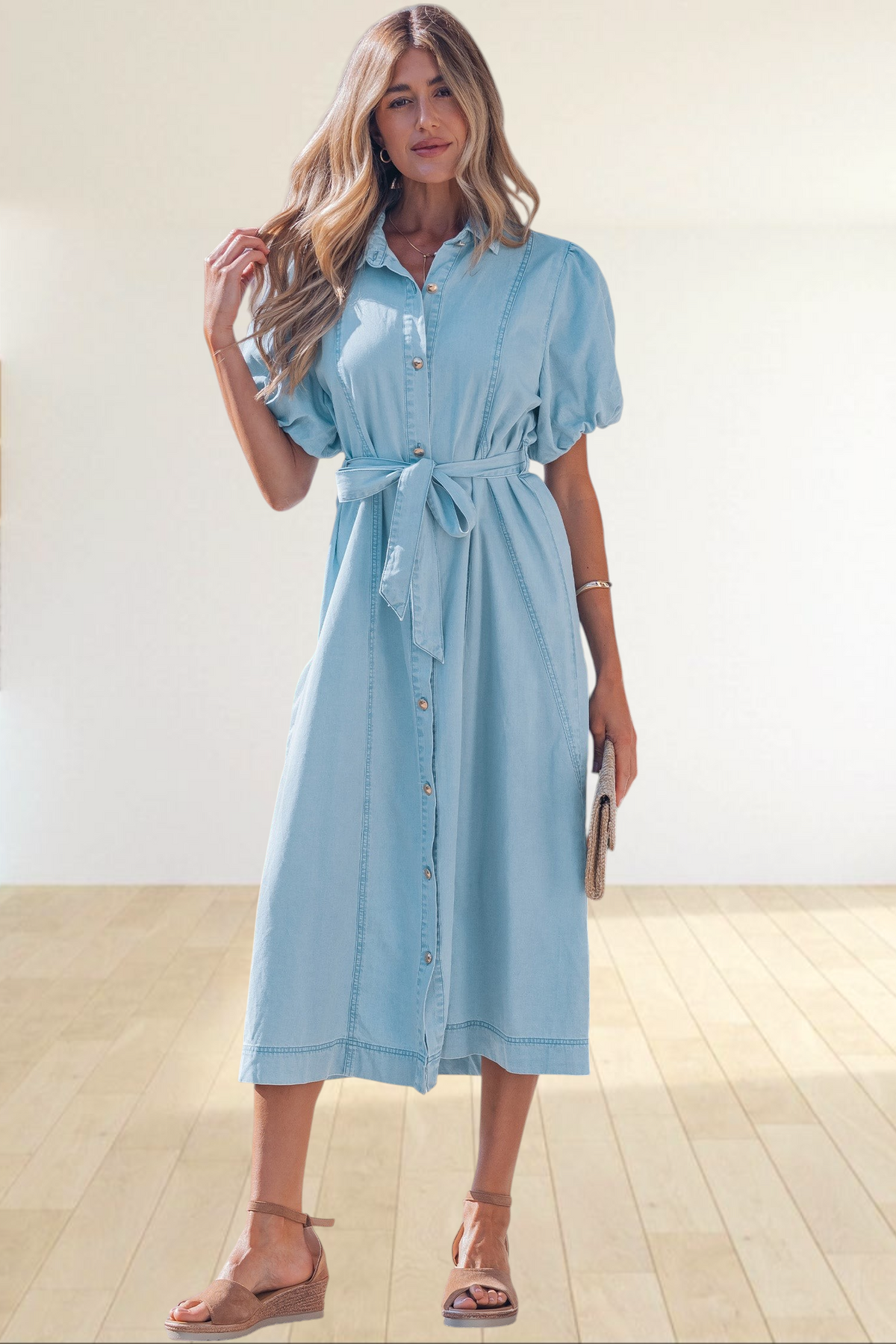 Baya Wear light wash denim midi dress with puff sleeves, button-down front, and tie-waist belt worn by a woman.