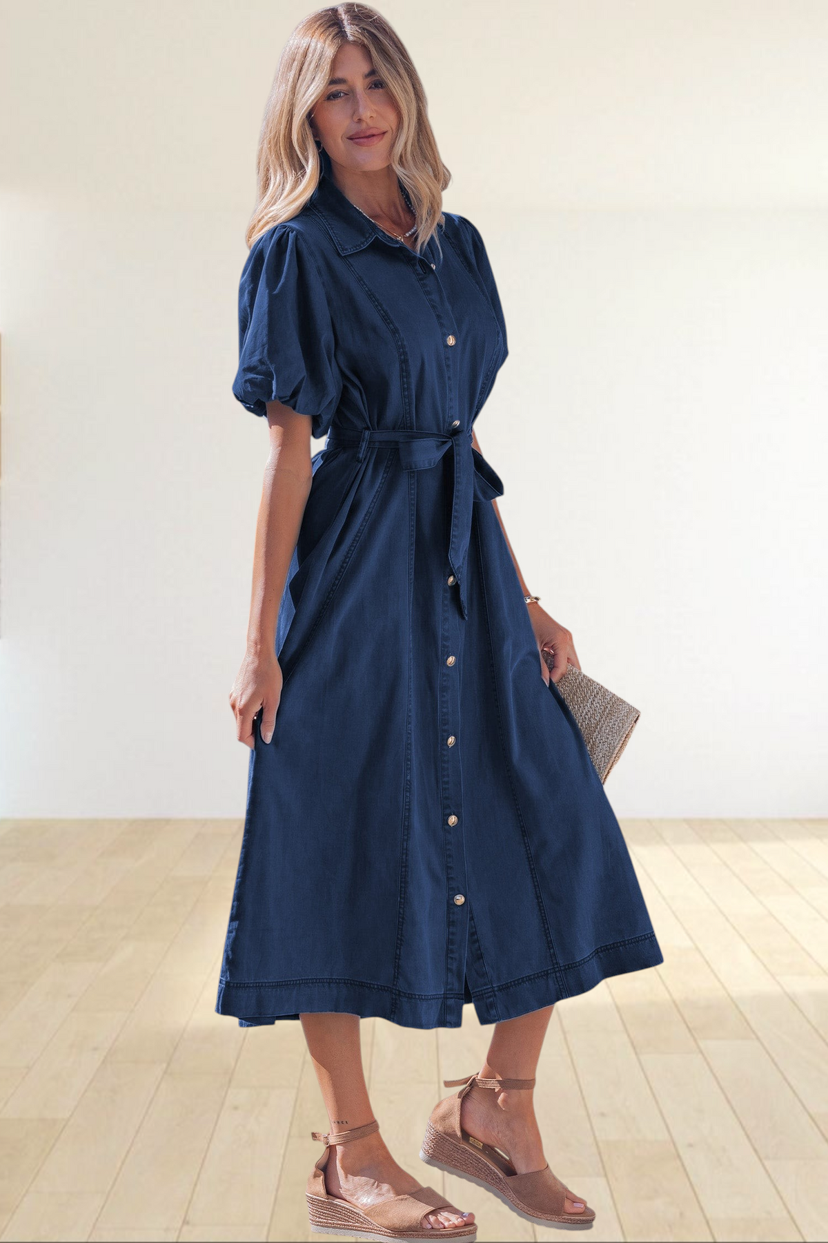 Baya Wear dark blue denim midi dress with puff sleeves, button front, and tie waist belt worn by a woman outdoors.