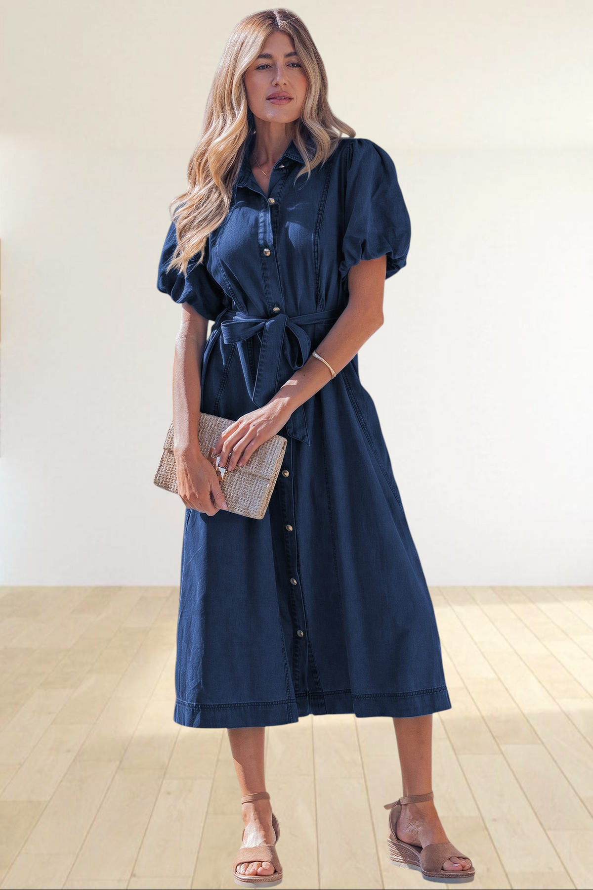 Baya Wear dark blue denim midi dress with puff sleeves, button-down front, and tie-waist belt worn by a woman.