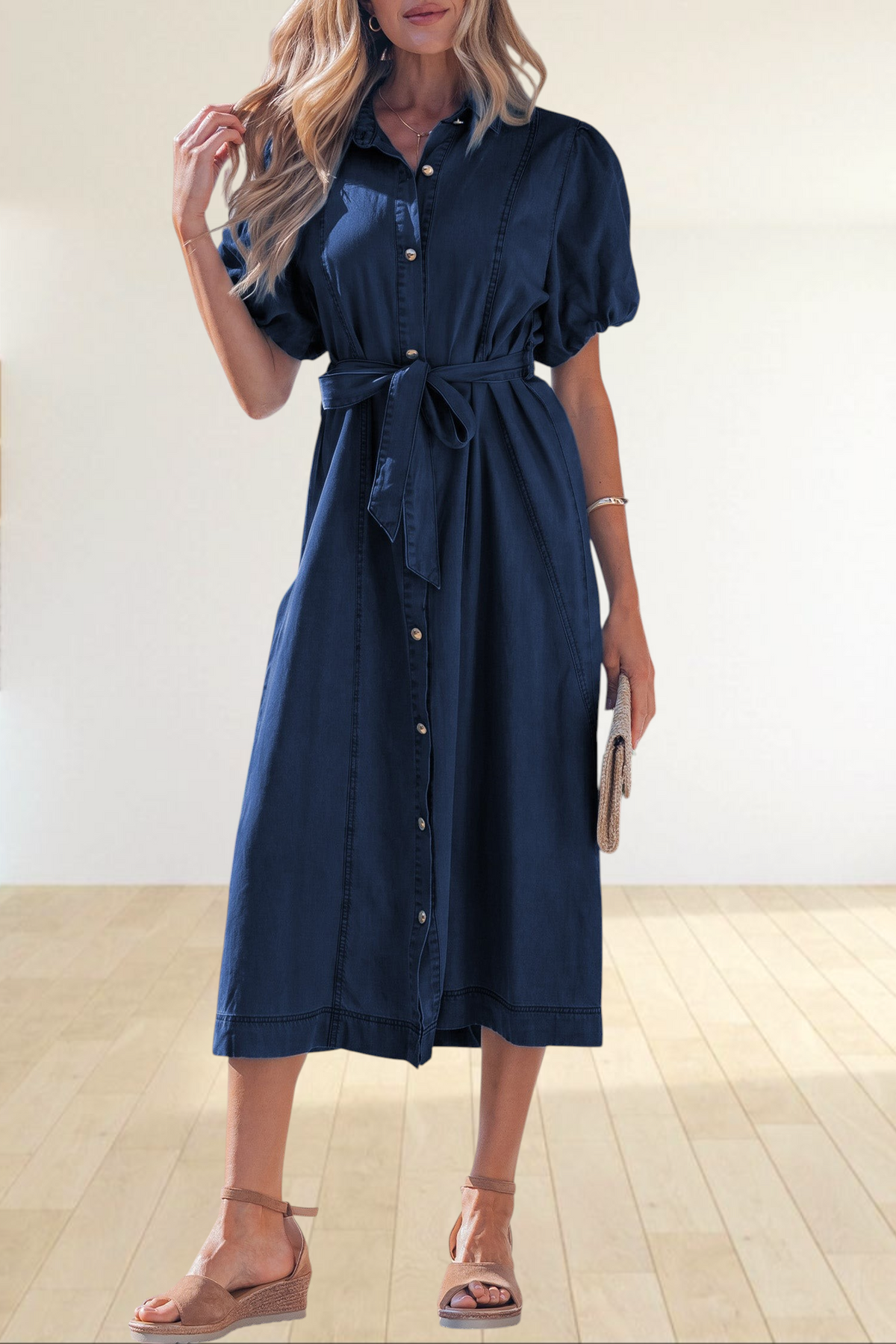 Baya Wear dark blue denim midi dress with puff sleeves, button-down front, and tie-waist belt worn by a blonde model.