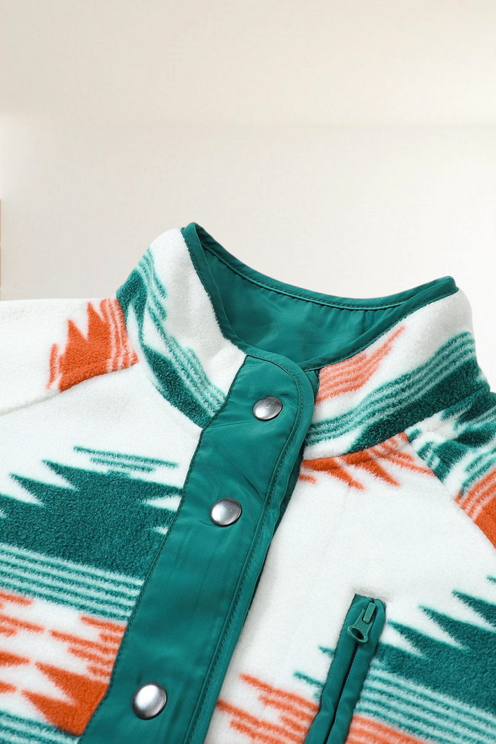 Baya Wear cream fleece jacket with geometric orange and green pattern, snap buttons, and high collar detail.