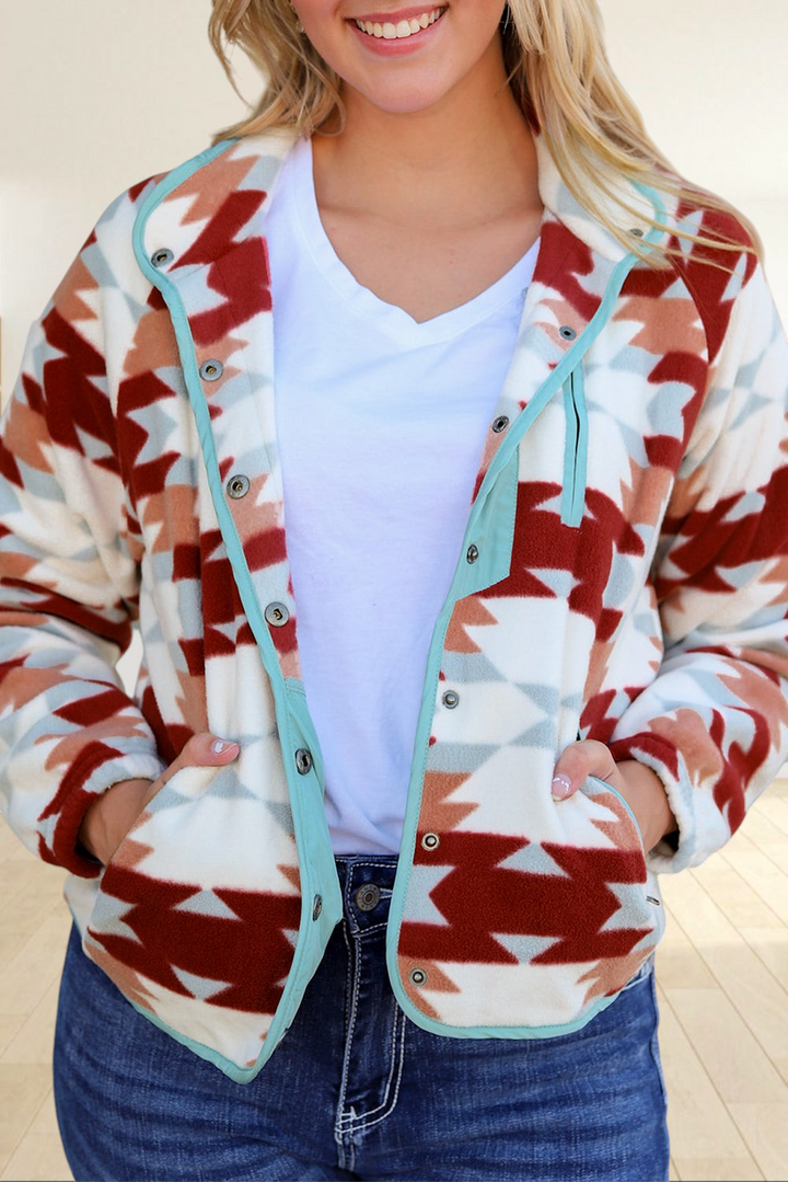 Baya Wear geometric patterned fleece snap jacket in fiery red, cream, and blue with a button-front and pockets.