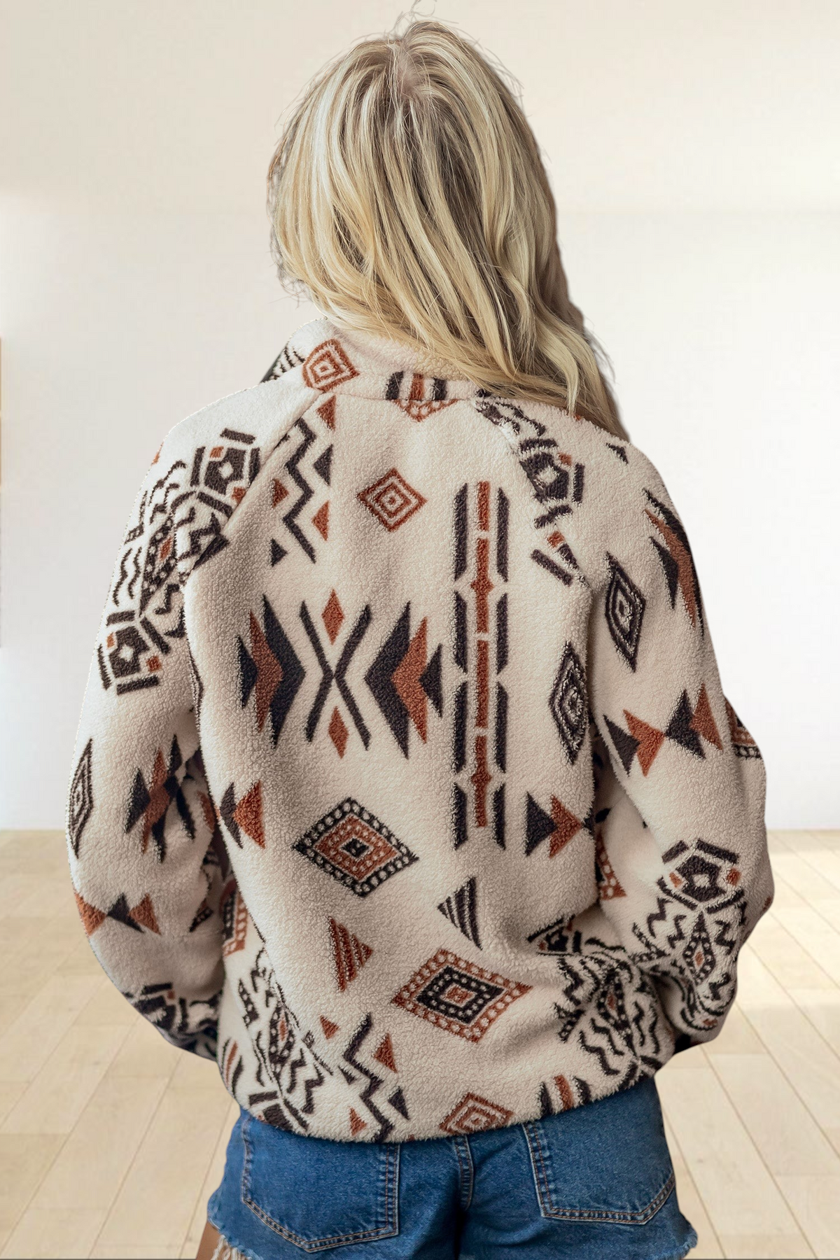Baya Wear beige sherpa fleece jacket with a brown and cream geometric southwestern print, back view on a blonde model