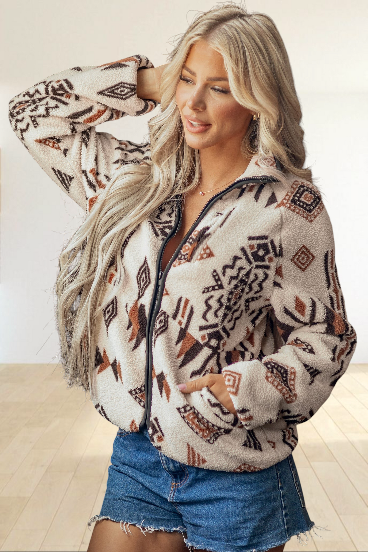 Baya Wear beige sherpa fleece zip-up jacket with brown geometric print, collar, and side pockets on a blonde model.