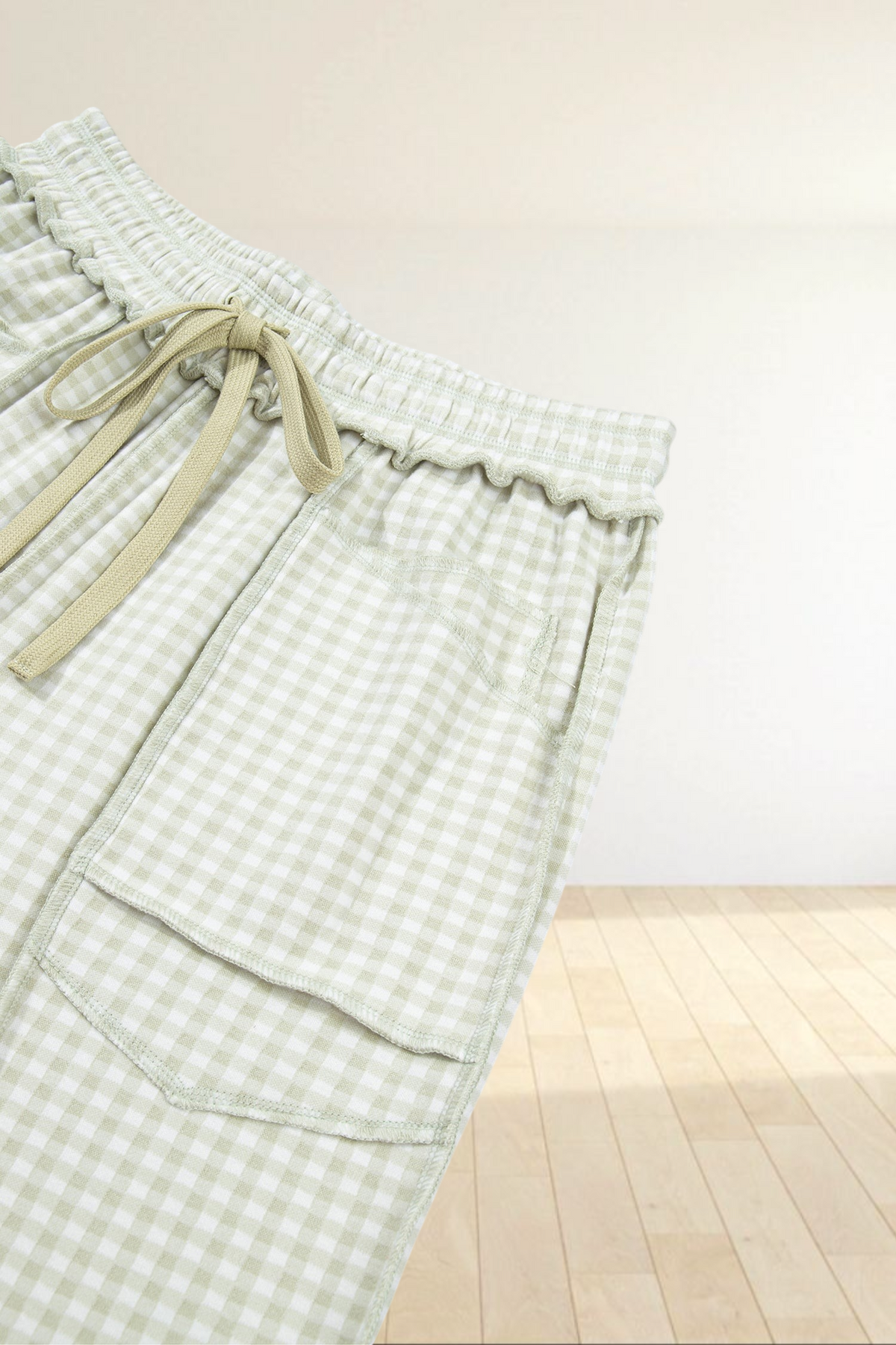 Baya Wear light green and white gingham lounge pants with an elastic drawstring waist and large front patch pockets.