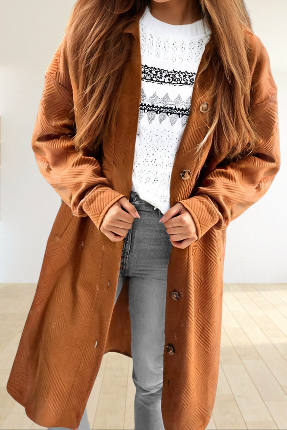 Baya Wear gold textured longline button down shirt jacket with drop shoulders and pockets worn over a white sweater.