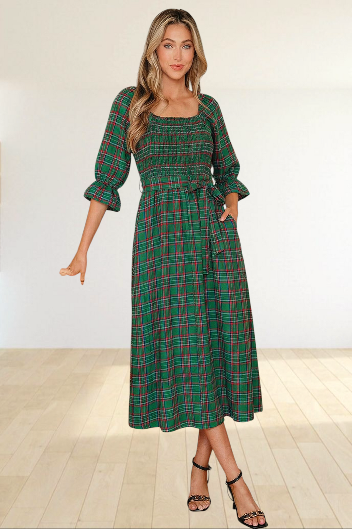 Baya Wear green tartan plaid midi dress with smocked bodice, puff sleeves, and side pockets worn by a blonde model.