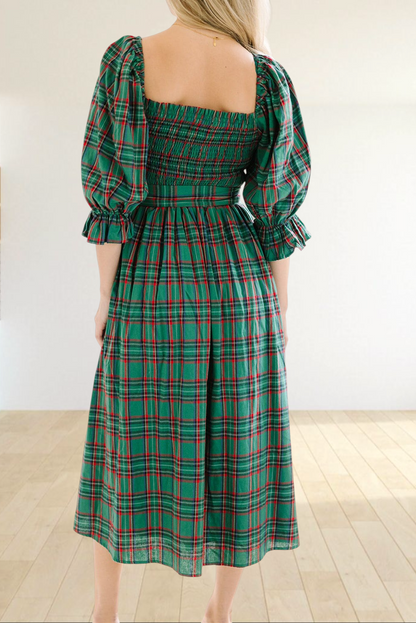 Baya Wear green tartan plaid midi dress with smocked bodice, puff sleeves, and ruffled cuffs, back view.