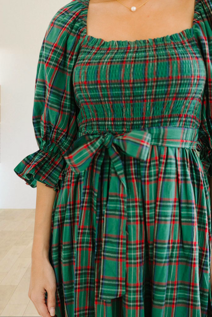Baya Wear green tartan plaid midi dress with a smocked bodice, square neckline, puff sleeves, and a waist tie.