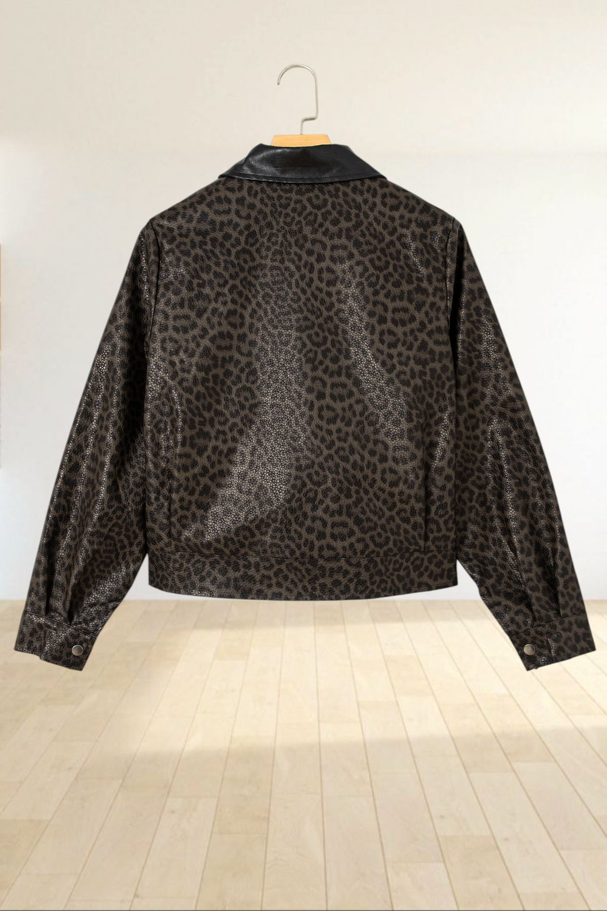 Baya Wear leopard print cropped jacket with a solid black collar, shown from the back on a hanger.