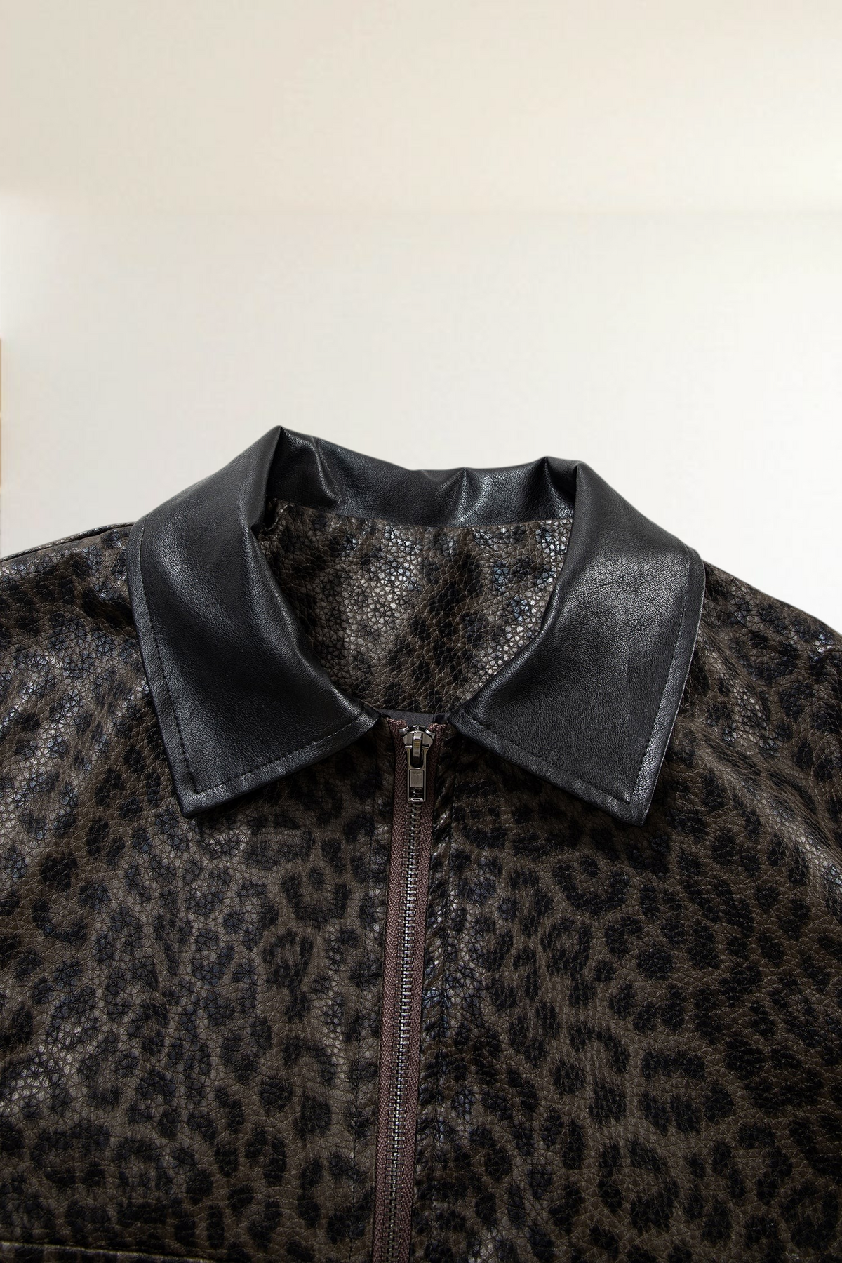 Baya Wear leopard print jacket with a black collar and front zip closure in a textured material
