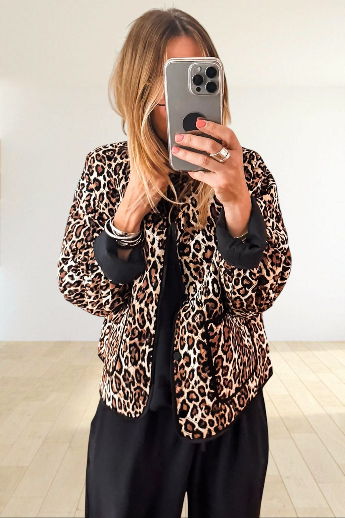 Baya Wear brown leopard print quilted button-up jacket with black trim and patch pockets worn by a woman