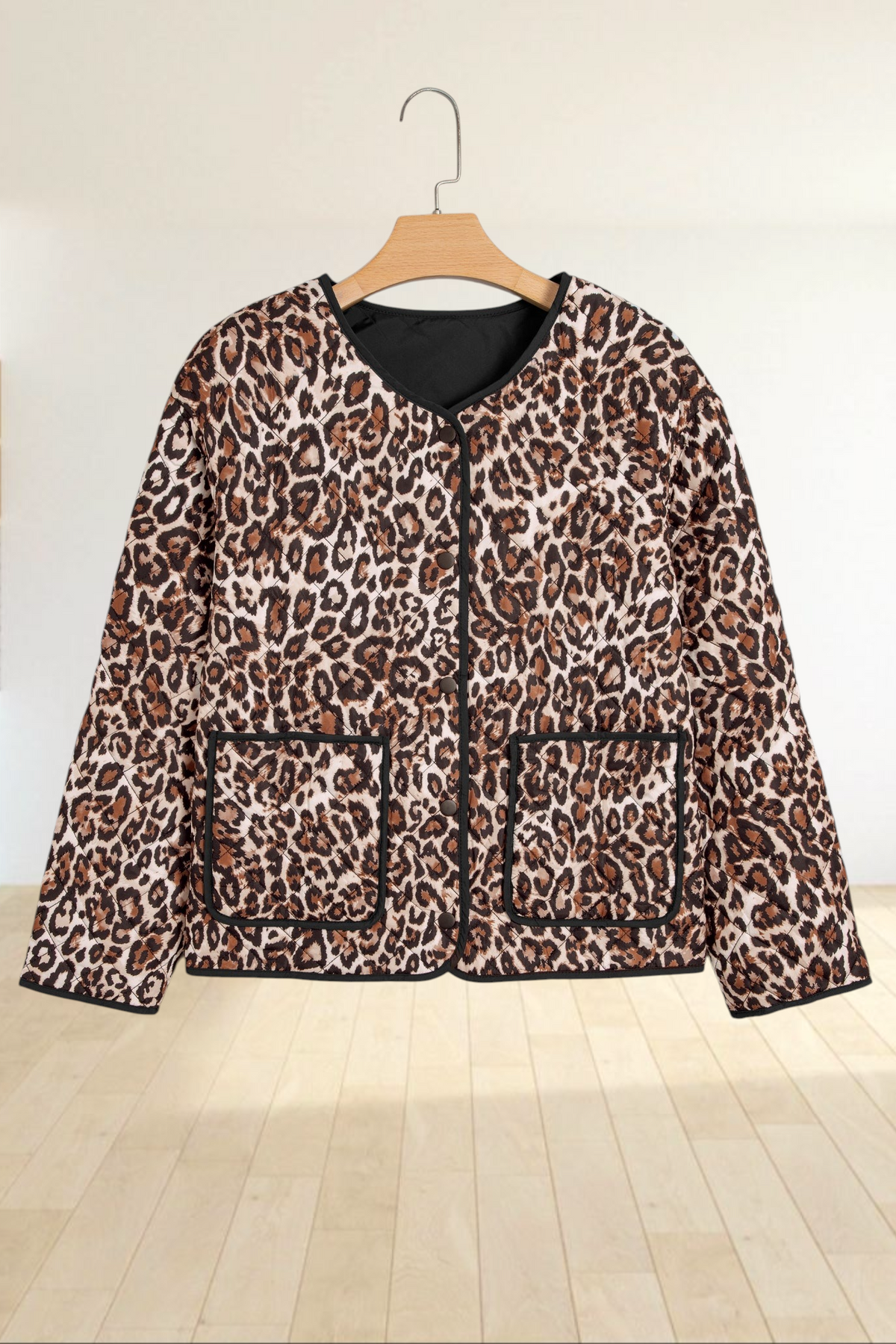 Baya Wear brown leopard print quilted jacket with black trim, button front, and two front patch pockets.
