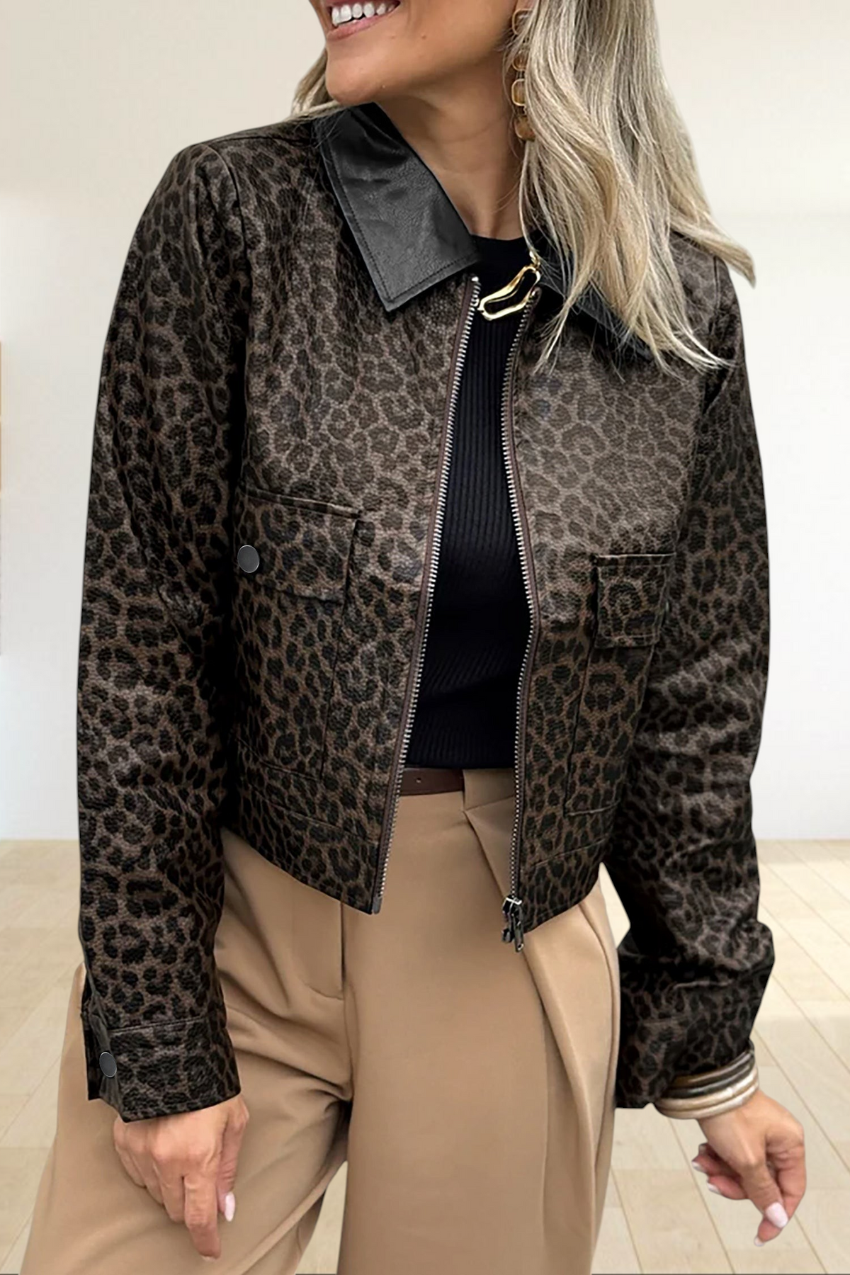 Baya Wear cropped leopard print jacket with a black collar, metal zip-up front, and snap-button pockets.