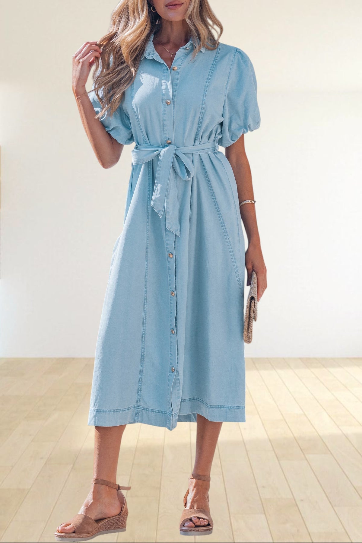 Baya Wear light blue denim midi dress with puff sleeves, collared neckline, button front, and tie-waist belt.