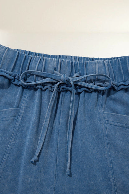 Baya Wear blue mineral wash lounge pants featuring a gathered drawstring waist and detailed seam stitching.
