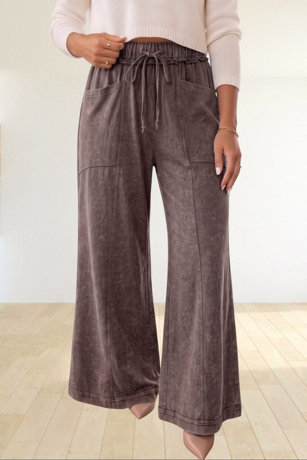 Baya Wear mineral wash flare leg lounge pants with drawstring waist, seam detailing, and pockets in a dark grey tone.