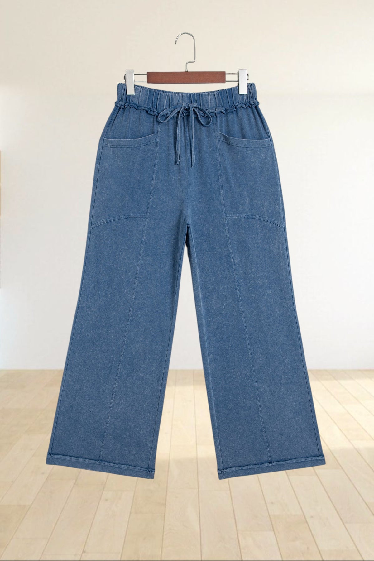 Baya Wear blue mineral wash flare leg lounge pants with a drawstring waist, seam details, and front pockets.