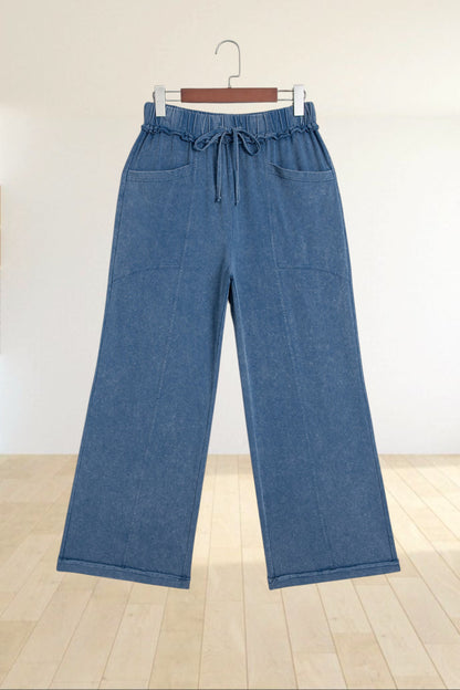 Baya Wear blue mineral wash flare leg lounge pants with a drawstring waist, seam details, and front pockets.
