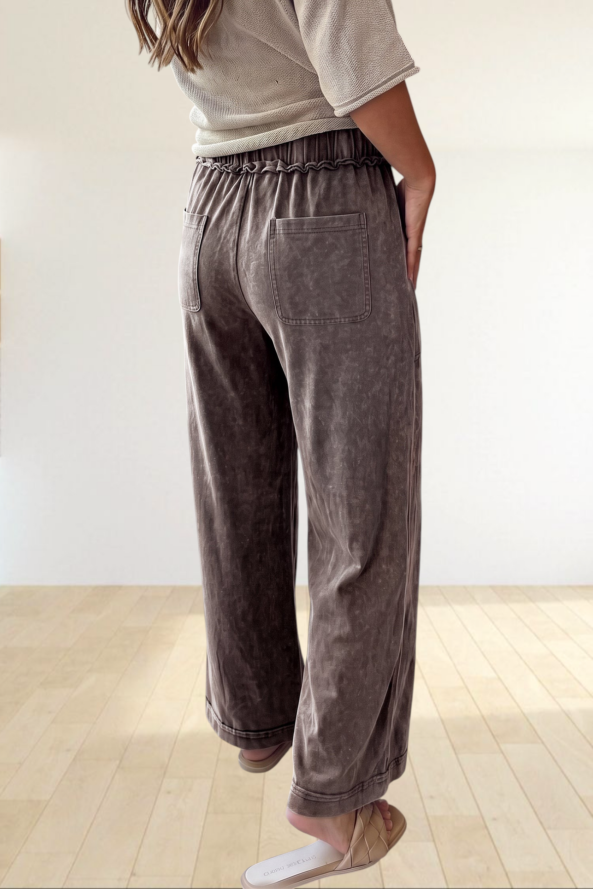 Baya Wear mineral wash wide leg lounge pants with drawstring waist, back pockets, and seam detail in brown.