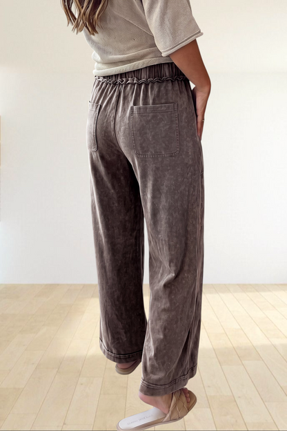 Baya Wear mineral wash wide leg lounge pants with drawstring waist, back pockets, and seam detail in brown.