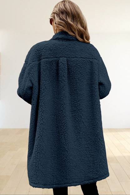 Baya Wear longline navy blue teddy fleece shacket with a relaxed fit worn by a woman standing on outdoor stairs