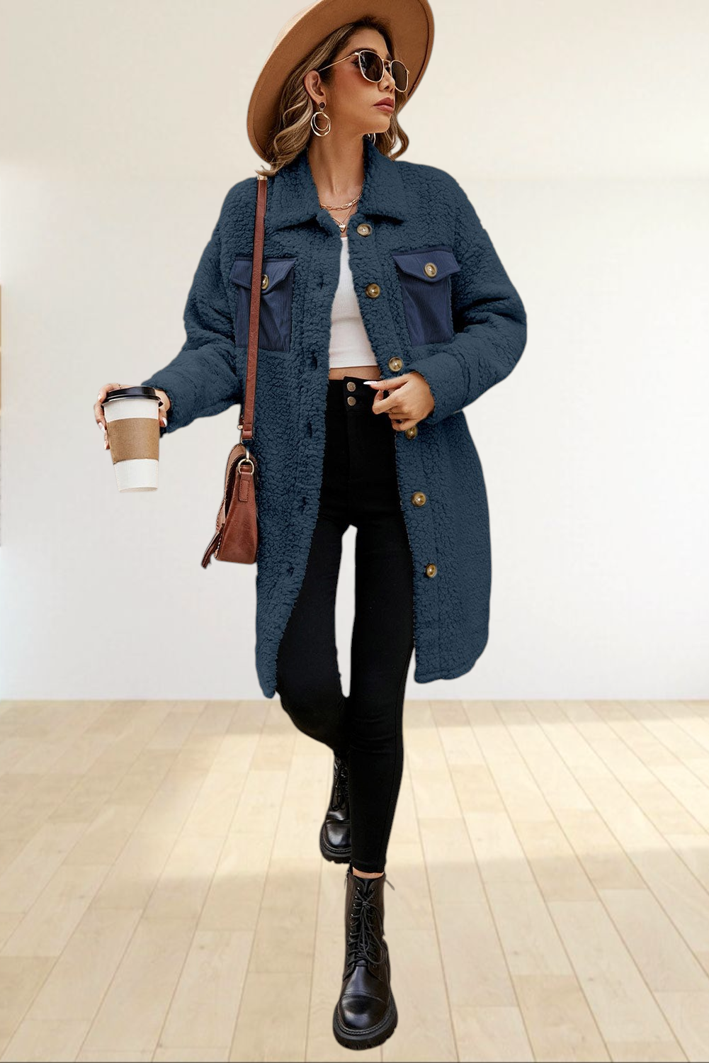 Baya Wear navy blue longline teddy fleece shacket with contrast corduroy chest pockets worn by a woman on stairs