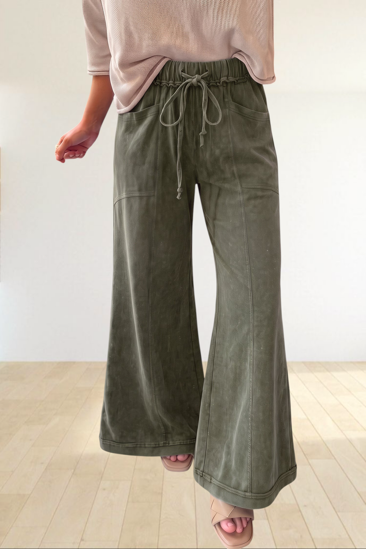 Baya Wear olive green mineral wash flare leg lounge pants with drawstring waist and seam detailing.