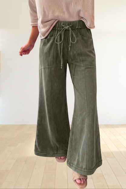 Baya Wear olive green mineral wash flare leg lounge pants with drawstring waist and seam detailing.
