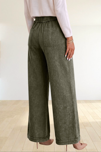 Baya Wear olive green mineral wash flare leg lounge pants with a drawstring waist and back pockets, back view.