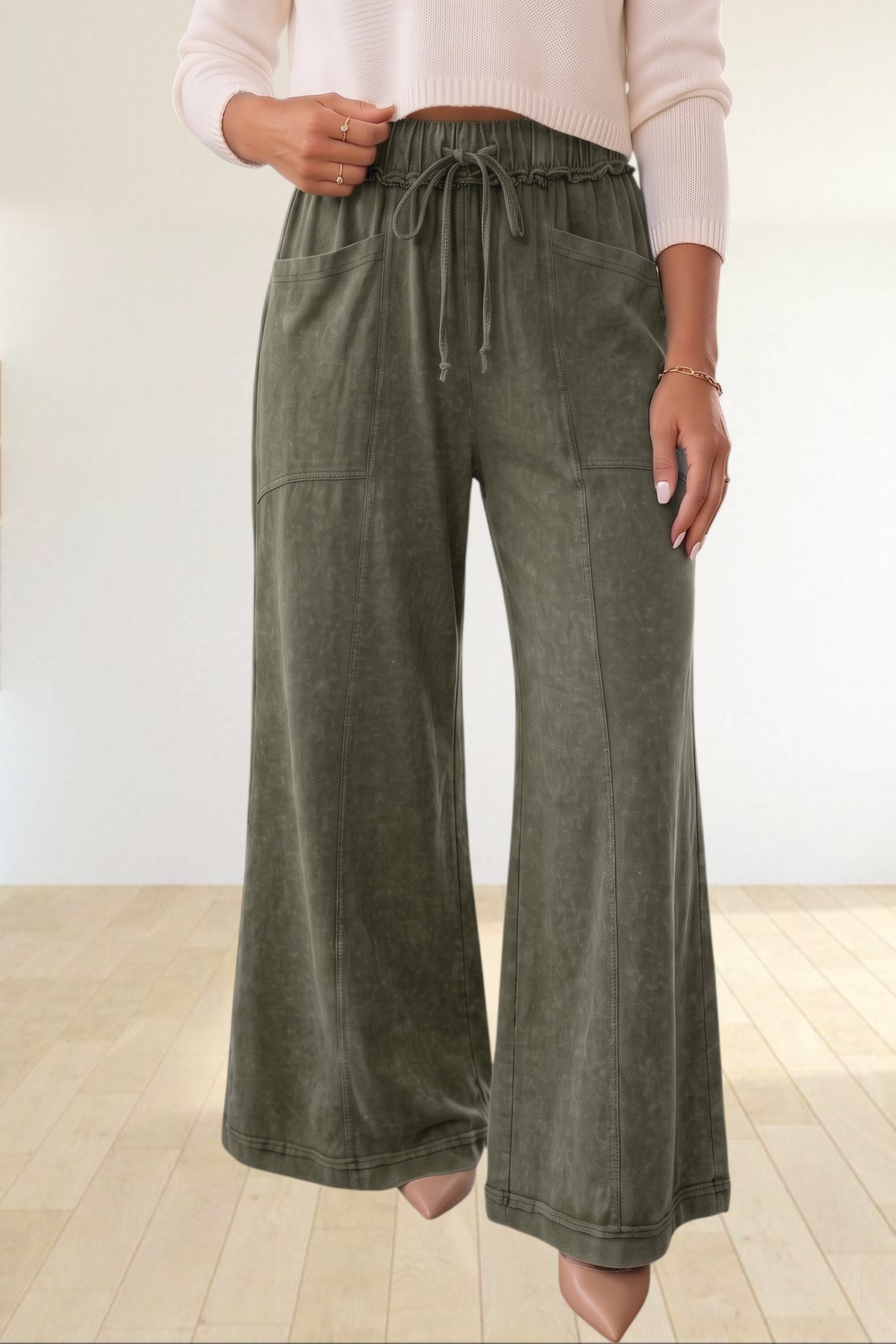 Baya Wear olive green mineral wash flare leg lounge pants with drawstring waist and seam details on a model.