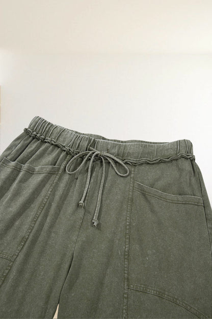 Baya Wear olive green mineral wash lounge pants with a drawstring waist, seam detailing, and side pockets.