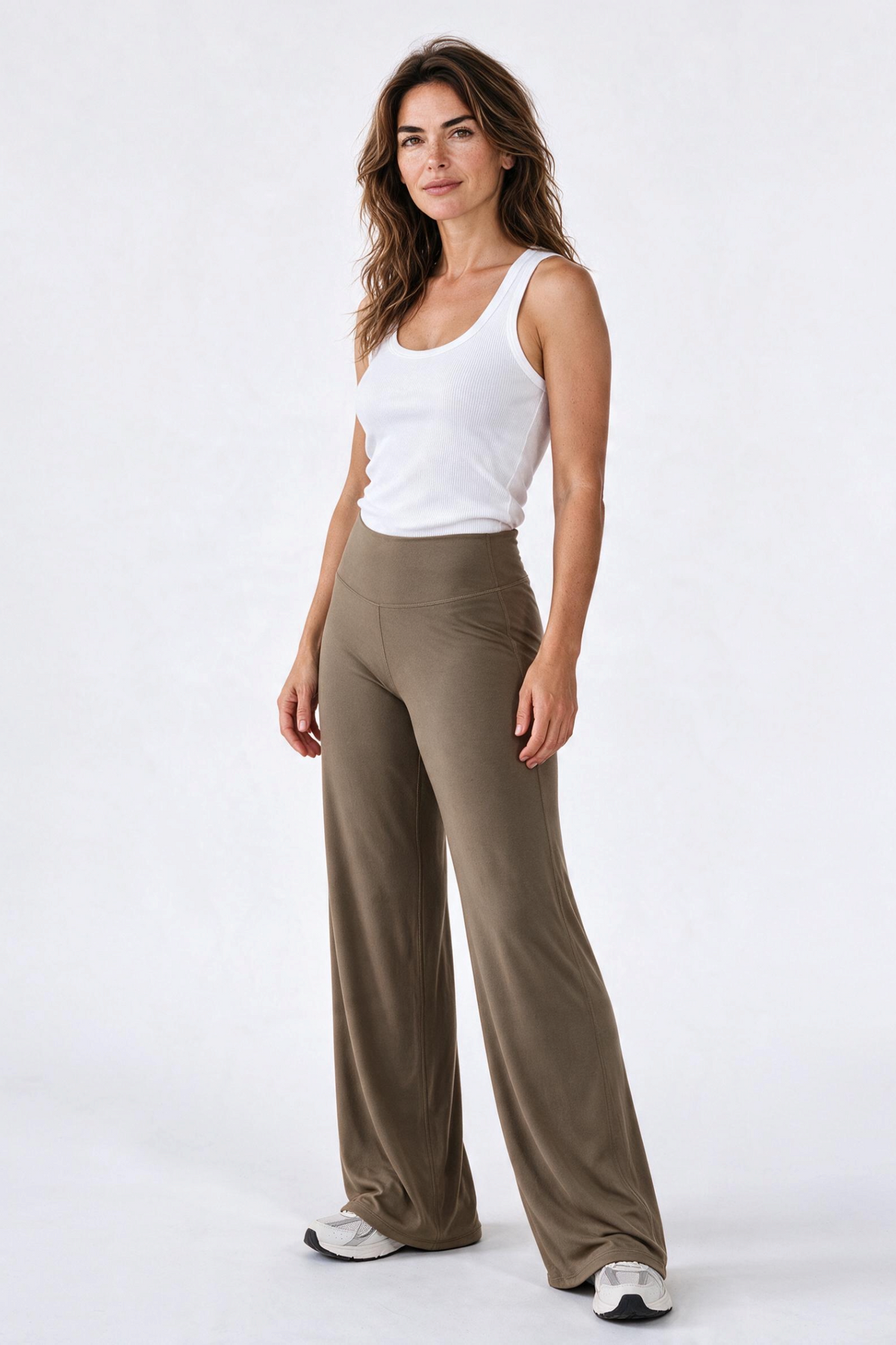 Baya Wear high-waisted wide leg yoga pants in olive green paired with a white tank top on a model