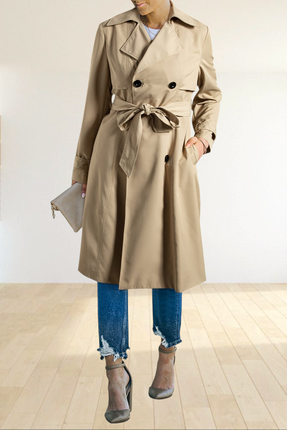 Baya Wear pale khaki double-breasted trench coat with a waist-tie belt, worn with distressed jeans and heels.